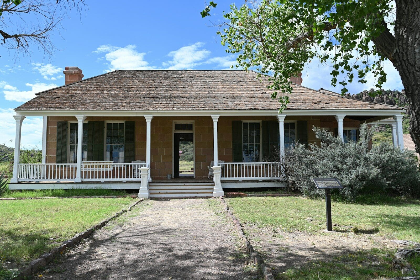 Historic stone house with a wide wraparound porch